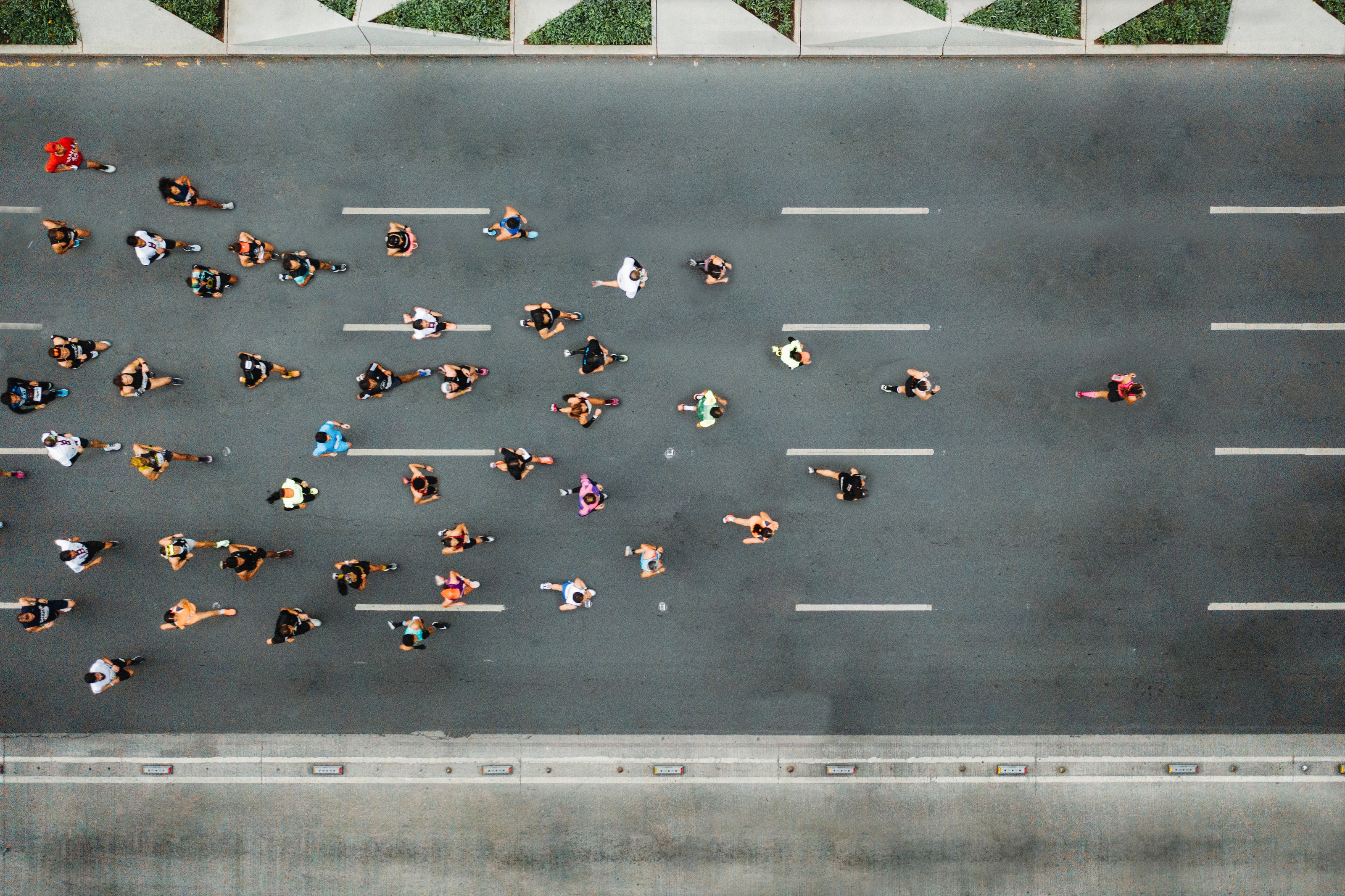 Top-down view of an Ekai Drinks running event on a road with runners.